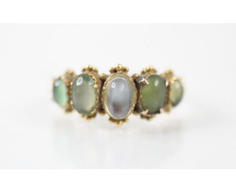 A 20th century untested moonstone ring, the five graduated oval cabochon stones set within a closed back yellow metal mount w