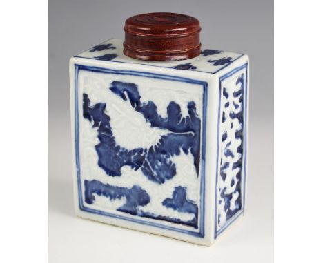 A Chinese porcelain blue and white tea caddy, 18th century, of rectangular form and relief decorated with dragons, with later