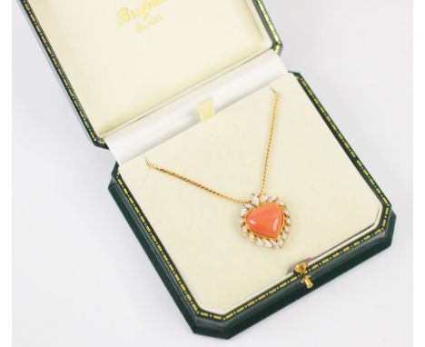 An 18ct yellow gold untested coral and diamond necklace, the heart shaped coral pendant with stylised leaf diamond set surrou