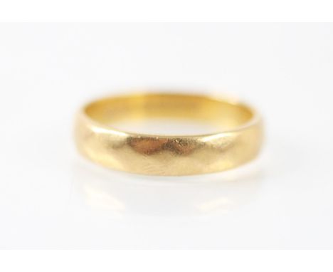 A 22ct yellow gold wedding band, the faceted band stamped 'H&amp;M' Birmingham 1979, ring size P 1/2, 5.1gms 