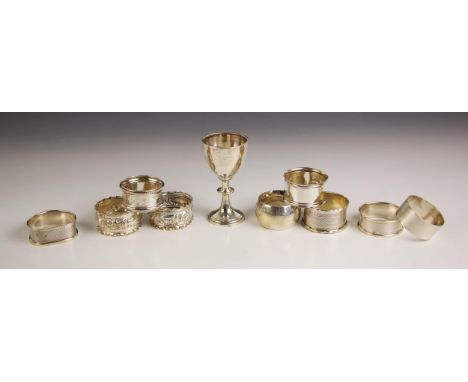 A collection of nine silver napkin rings with mixed engine turned and floral detailing, to include two Birmingham 1900, two B