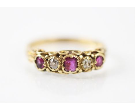 An early 20th century untested ruby and diamond ring, the central cushion cut ruby with old cut diamond and further smaller c