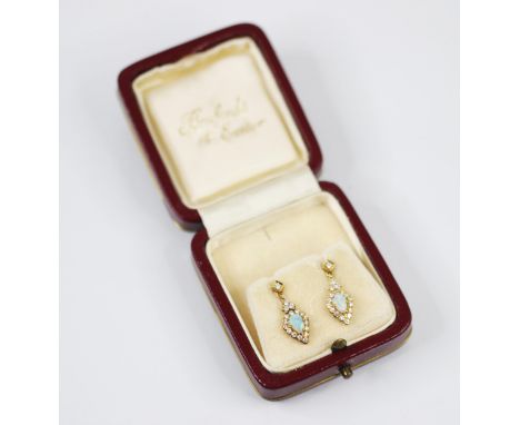 A pair of 18ct yellow gold white opal and diamond earrings, the round cut diamond within a rubover setting, suspending a tear