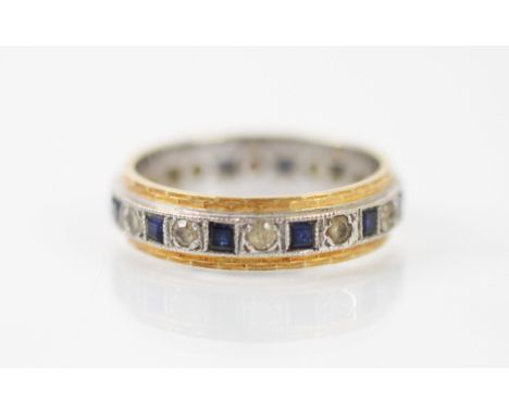 An untested sapphire and paste eternity ring, the calibre cut sapphires interspersed with round cut paste stones, set within 