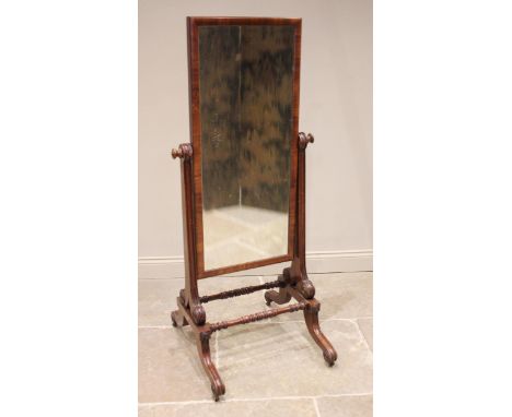 A Regency mahogany cheval mirror, the rectangular mirrored plate within a plain moulded frame, upon channelled supports exten