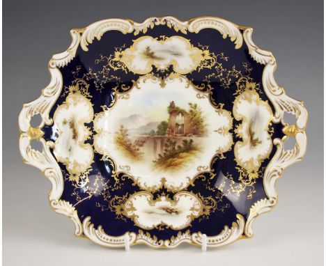 A Coalport two handled porcelain bon bon dish, late 19th/early 20th century, enamelled with an architectural capriccio signed