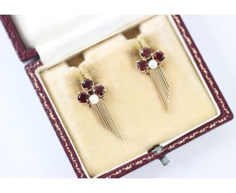 A pair of 'garnet' coloured earrings, the three round cut 'garnets' claw set with a central paste pearl designed as a part fl
