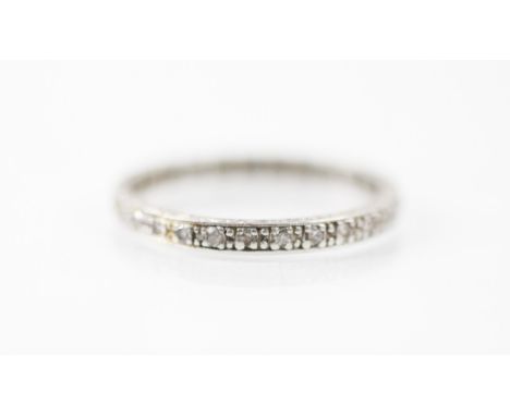 An Art Deco style diamond eternity ring, the twenty seven mixed cut diamonds set within a white metal mount, the sides of the
