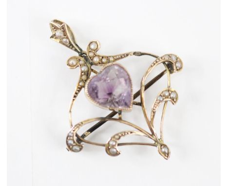 An Edwardian style amethyst and seed pearl set brooch/pendant, the central heart shaped amethyst within a split pearl set sur