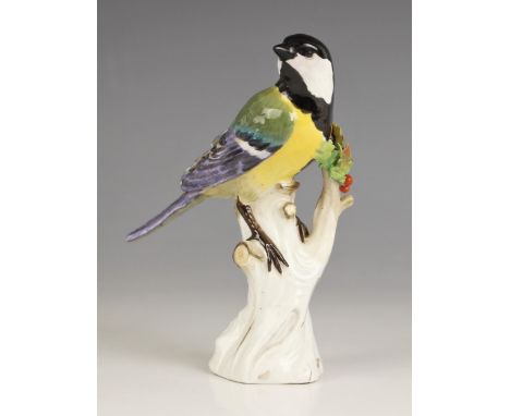 A Meissen porcelain model of a Great Tit, 19th century, perched upon a branch with gilt highlights, incised '1123', 13.5cm hi