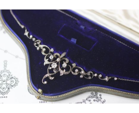 A late 19th century diamond swag necklace/brooch, the central openwork detachable brooch with four old cut diamonds in cut do