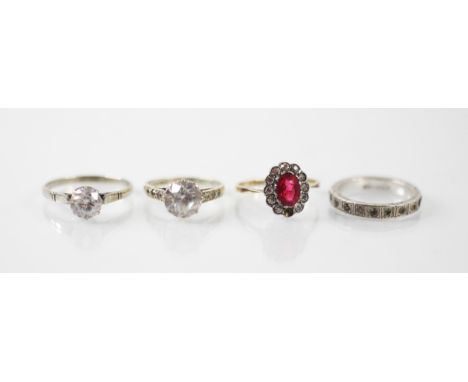 A selection of four rings, including a single stone untested synthetic moissanite ring set within 9ct yellow gold, ring size 