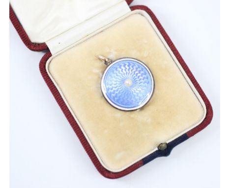 A 20th century guilloche enamel pendant/locket, the circular pendant with light blue guilloche enamel decoration with applied