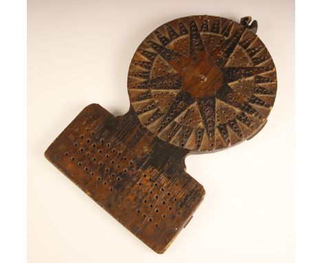 An 18th century provincial carved and painted wooden Traverse Board, the circular upper section with an eight point compass s