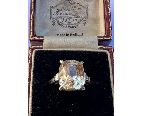 An Art Deco style certified 9 carat yellow sapphire, the central mixed cut sapphire with apricot hue (weight certified as 9.0