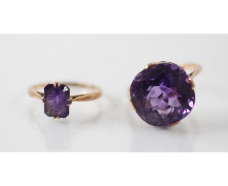 An untested amethyst dress ring, with stylised claw set mount and plain polished shank, stamped '9ct' ring size N 1/2, with a