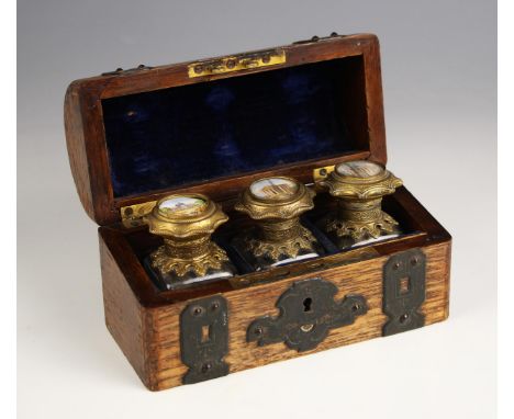 A Grand Tour oak cased inkwell set, early 19th century, modelled as a domed trunk of small proportions, the domed hinged cove