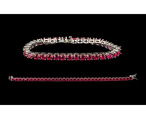 Ruby Tennis Bracelet, 34 round cut rubies of rich, glowing red, each measuring just over half a carat, an overall total of 20