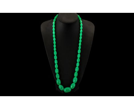 A String of Jade Lucite Graduated Beads. 30 inches in length.