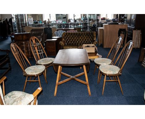 Ercol Elm Golden Dawn Dining Room Set comprising an oval drop-leaf table with four Windsor back stand chairs with a carved sw