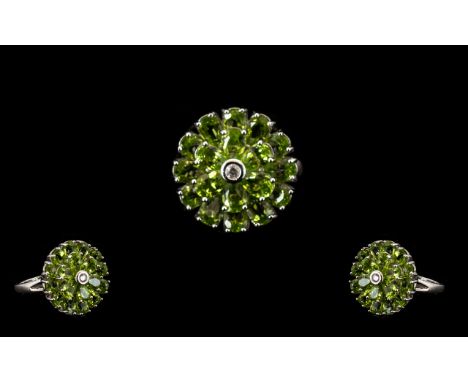 Peridot Circular Floral Style Ring, two circles of pear cut peridots, the inner circle slightly above the first, has a bezel 