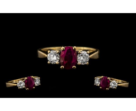 Ladies 9ct Gold 3 Stone Ruby and Diamond Set Dress Ring - the central ruby flanked by two brilliant cut diamonds of good colo