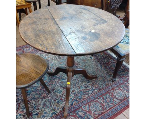 An 18th century oak tripod  table. 69 cm x 67cm diameter 