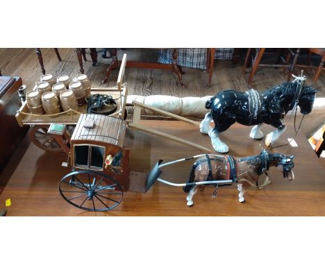 A ceramic shire horse pulling a cart of nine barrels, and a horse pulling a Victorian cab. 