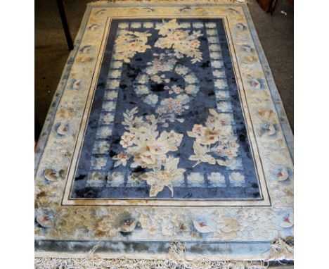A Chinese hand knotted silk rugby Kayam, floral decoration on a Royal blue ground, with silver-blue floral border, 72 x 48in.