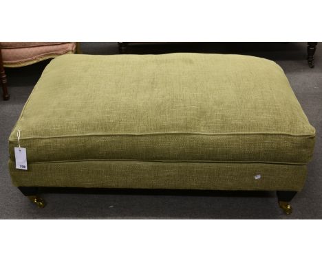A large modern green upholstered pouffe.  