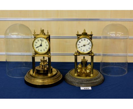 Two brass anniversary clocks with glass domes early to mid 20th century, one signed Gustav Becker, both having single train m