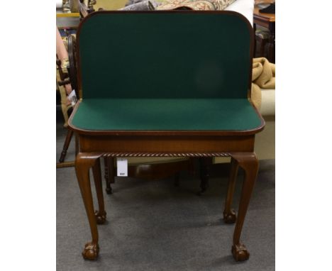 A 1920s mahogany card table in the George I style with gadroon carved front and cabriole legs with ball and claw feet.  