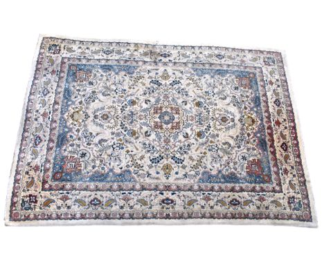 A large Kashan style carpet,&nbsp;the ivory field with single central pendant medallion and all over floral and foliate decor