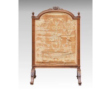A French carved walnut firescreen c.1900, in the Louis XVI style, the broken arch screen with original floral and swagged sil