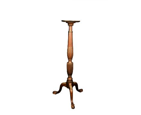 A late 19th century carved mahogany torchere with wheatear and reeded decoration, on tripod legs with ball and claw feet.  