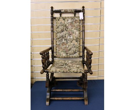 A late Victorian sprung-base rocking chair with bobbin turned frame 
