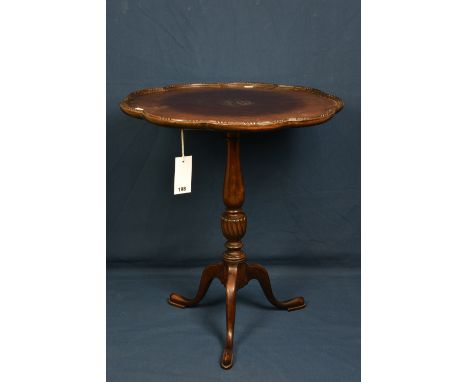 An Edwardian mahogany tripod table in the George III style with lobed dished top, baluster column and swept legs with pad fee