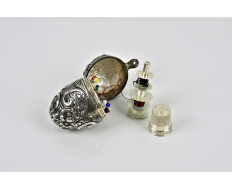 A novelty Continental silver repoussé egg form sewing etui late 19th century, the hinged cover opening to reveal a void with 