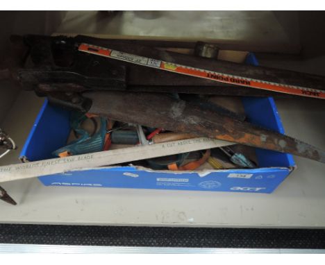 A selection of vintage hand tools including saws