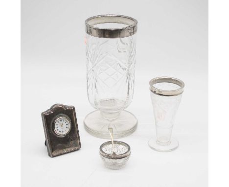 An Elizabeth II silver clad quartz clock, Sheffield 1993, h.9cm; together with two silver rimmed glass vases; and a silver ri