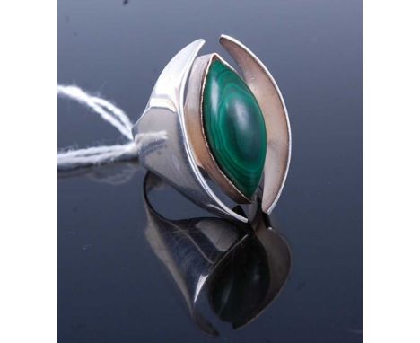 A modernist white metal and malachite set dress ring, setting dimensions 29x18mm, unmarked but probably silver, 15.7g, size R