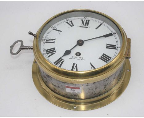A 20th century Smiths brass cased ship's bulkhead clock, the enamel dial showing Roman numerals, dia. 22cm, together with a l