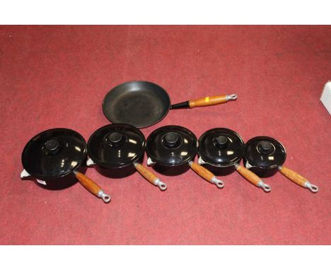 A set of five Le Creuset black enamel saucepans and covers, together with a matching Le Creuset frying pan (6)