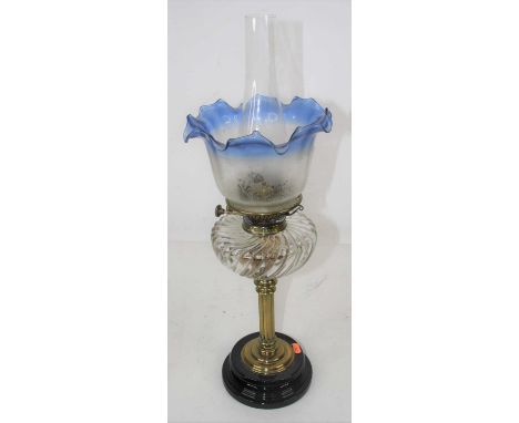 A late 19th century brass oil lamp, the blue tinted acid etched shade above a clear wrythen glass font, height 61cmCondition 