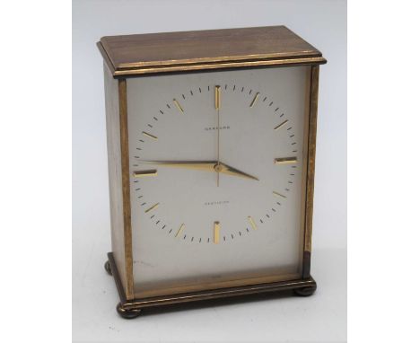 A 1970s brass cased mantel clock having a silvered dial with raised gilt baton markers, signed Garrard Precision, with presen