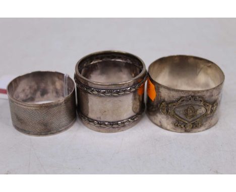 A George V silver napkin ring, having engine turned decoration and named cartouche; together with an early 20th century Germa