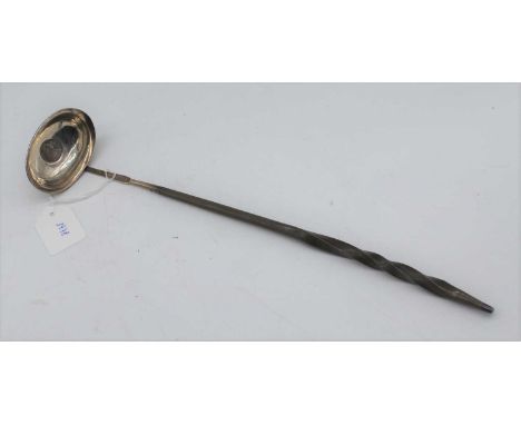 A George III silver toddy ladle having a plain oval bowled inset with a 1787 shilling on a turned whalebone handle, length 38