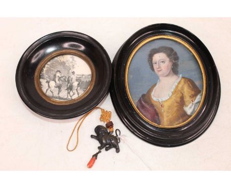 A pendant in the form of a mythical figure, having coral drop pendant; together with an oval portrait of woman; and one other