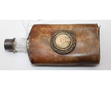 A 19th century hip flask, having a hobnail cut glass body, housed in a brown leather sleeve with inset portrait plaque, h.12c