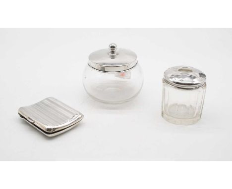 A George V silver cigarette  case, Birmingham 1922, 2.4oz, together with two silver lidded glass dressing table jars (3) 